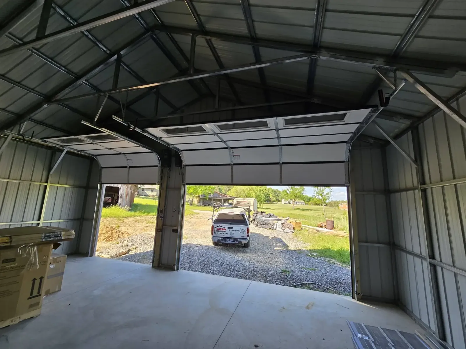 Interior view of a newly installed garage door in a metal shop building