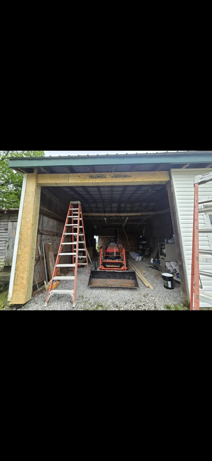 New garage door opening framed on an older outbuilding