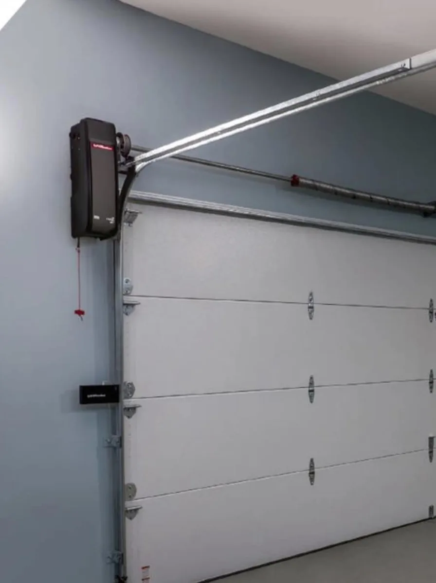 LiftMaster Elite 98022 wall-mount garage door opener installed beside a white garage door