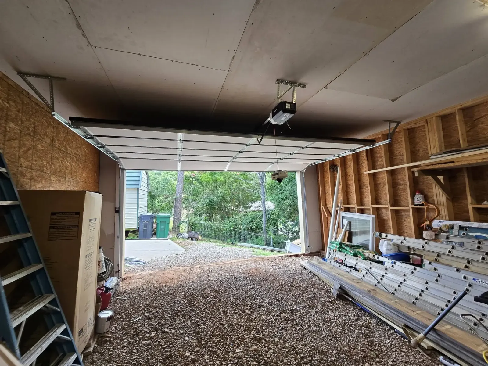 New garage door and opener installed in a detached garage